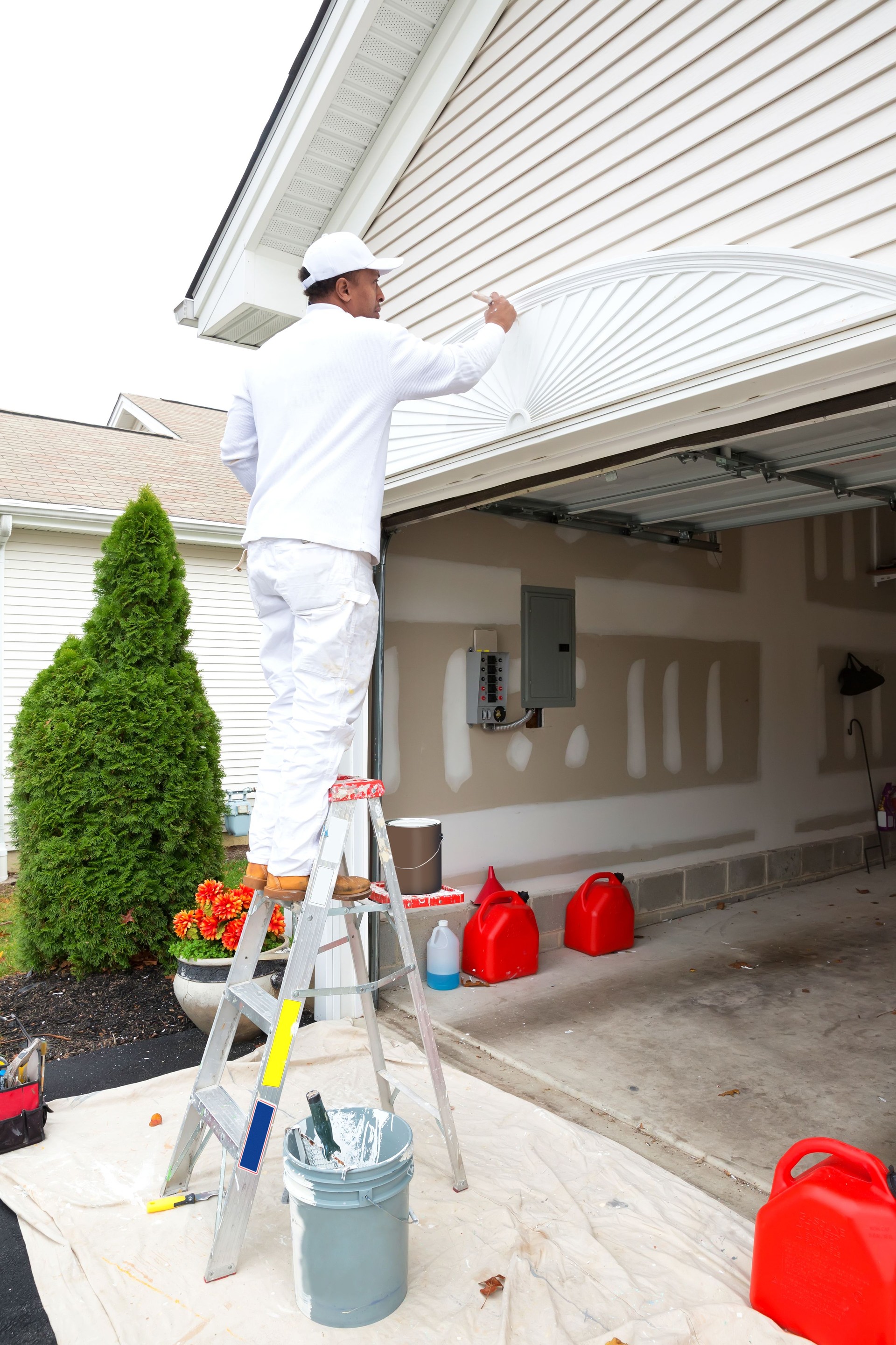 Painter paints the outside of a residential home